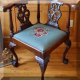 F35. Carved corner chair with needlepoint seat.